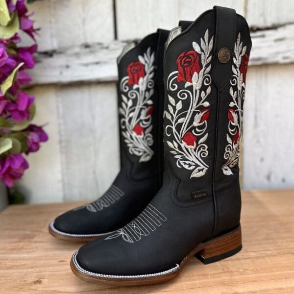 A pair of cowboy boots sitting on top of a table.