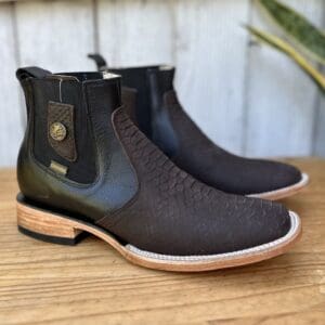 A pair of boots sitting on top of a wooden table.