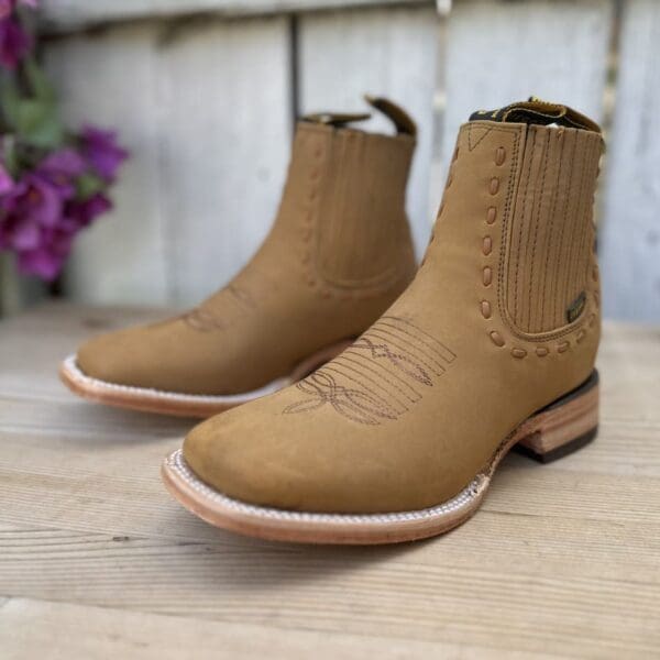 A pair of boots sitting on top of a wooden floor.