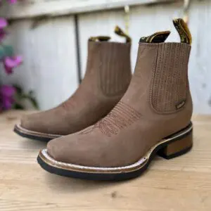 A pair of boots sitting on top of a wooden table.