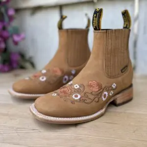 A pair of boots with flowers on them