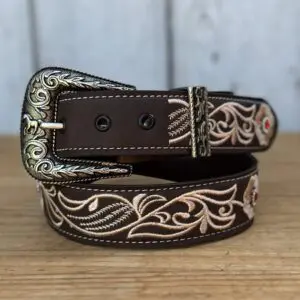 A brown and white belt sitting on top of a wooden table.