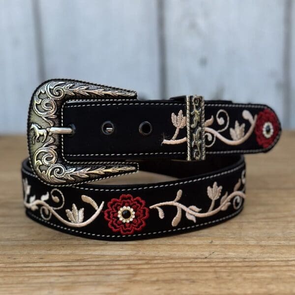 A black belt with red and white flowers on it