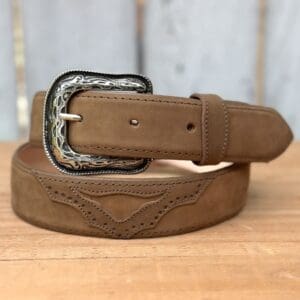 A brown belt with a silver buckle on top of a wooden table.