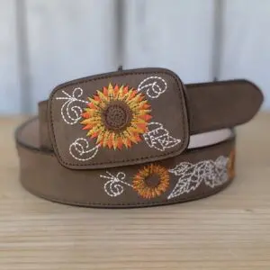 A brown belt with an embroidered sunflower on it.