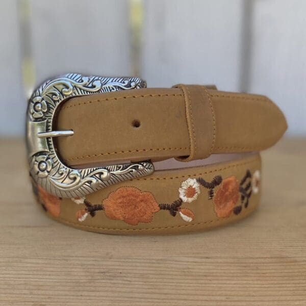 A close up of a belt with flowers on it