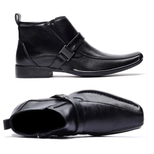 A pair of black shoes with a buckle on the side.