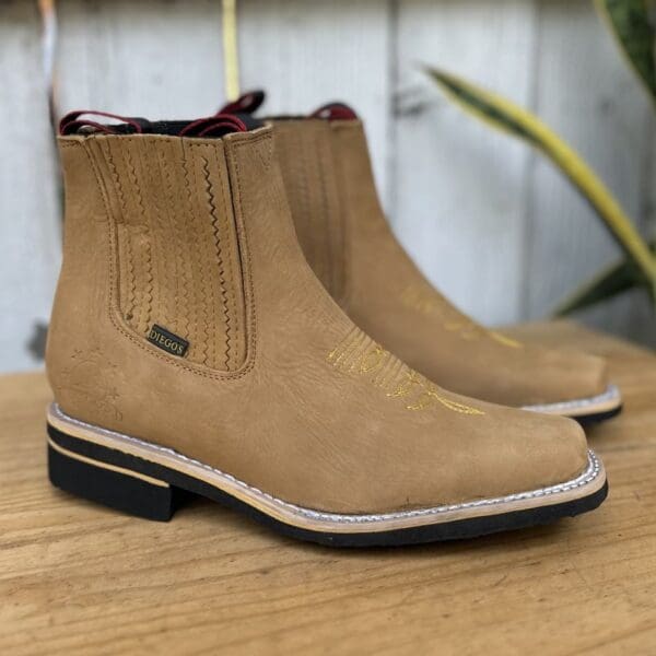 A pair of boots sitting on top of a wooden table.