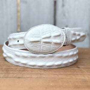 A white belt sitting on top of a wooden table.