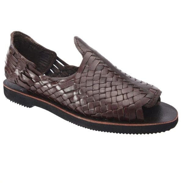 A brown sandal with a black sole and woven upper.