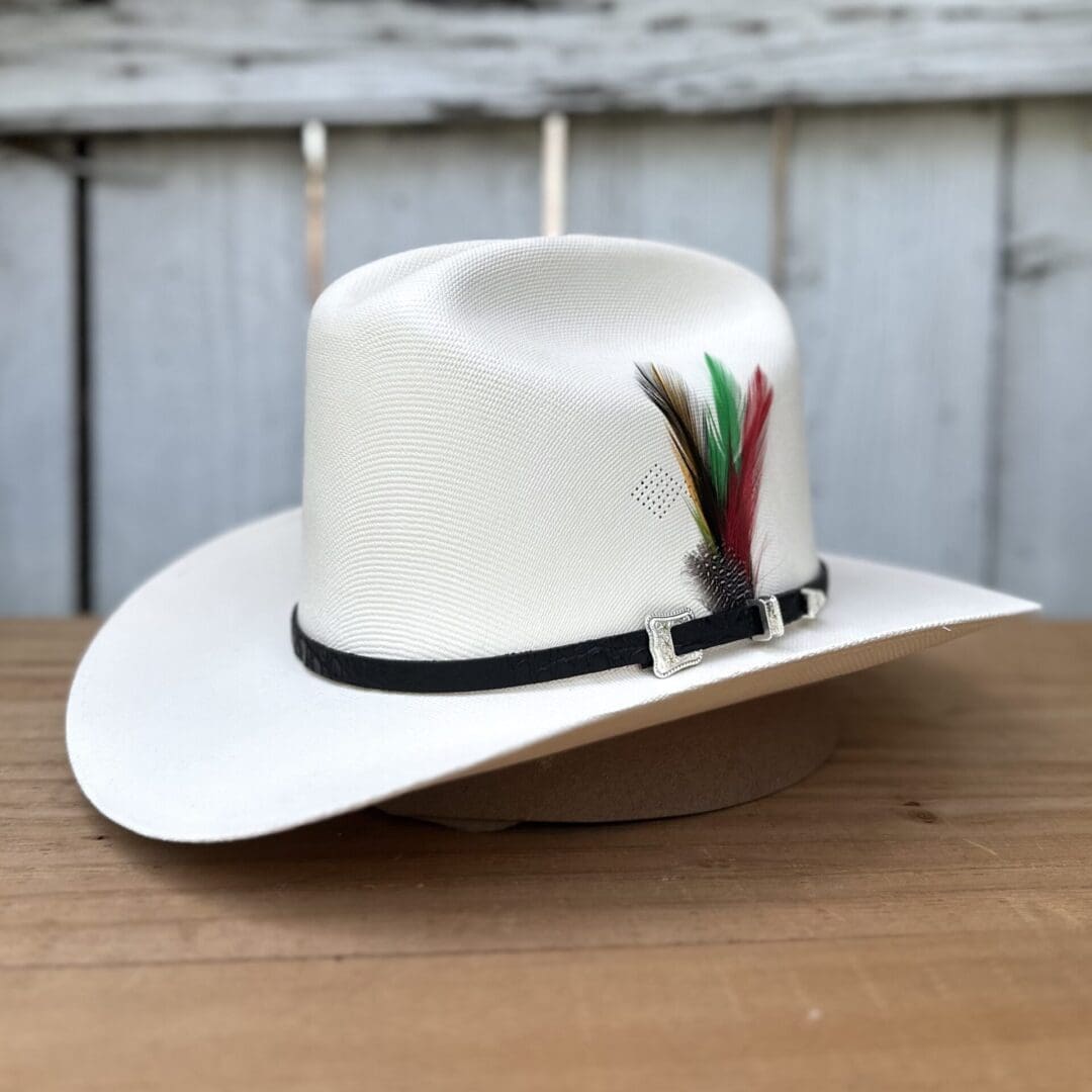 A white hat with feathers on top of it.